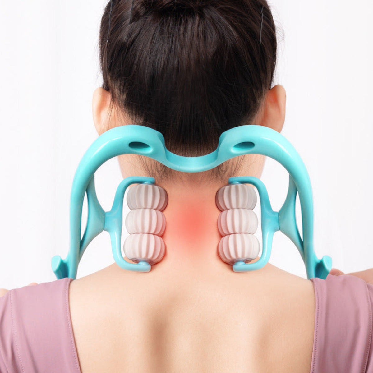 Person using a neck and shoulder massager on a white background